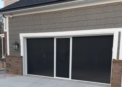 Garage screen with white frame and black mesh