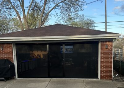 Garage door screen with black frame and black mesh